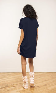 Back view of a woman wearing the coffee shoppe t-shirt dress. This short sleeve t-shirt dress is navy.