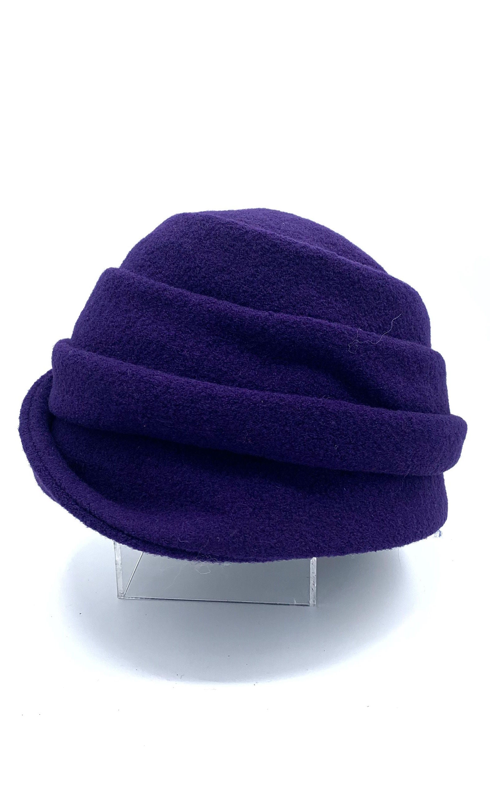 Left side view of the lillie & cohoe boiled wool lexi purple hat. This has a tiered look on the crown and a folded brim that stitches up on the right side