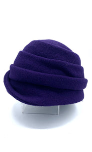 Left side view of the lillie & cohoe boiled wool lexi purple hat. This has a tiered look on the crown and a folded brim that stitches up on the right side