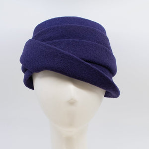 Front view of the lillie & cohoe boiled wool lexi purple hat. This has a tiered look on the crown and a folded brim that stitches up on the right side