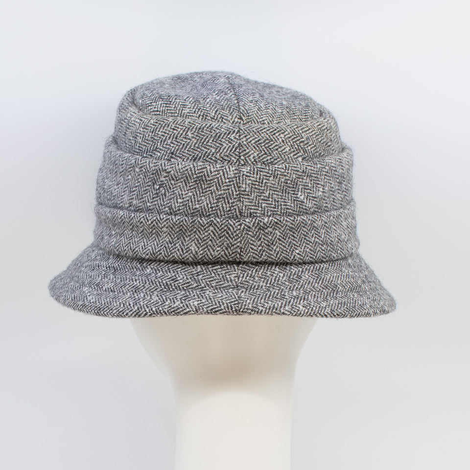 Back view of the lillie & cohoe herringbone vintage phoebe hat. This hat has an asymmetrical pointed brim, a layered crown, and a grey herringbone pattern.