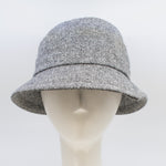Load image into Gallery viewer, Front view of the lillie &amp; cohoe herringbone vintage phoebe hat. This hat has an asymmetrical pointed brim, a layered crown, and a grey herringbone pattern.

