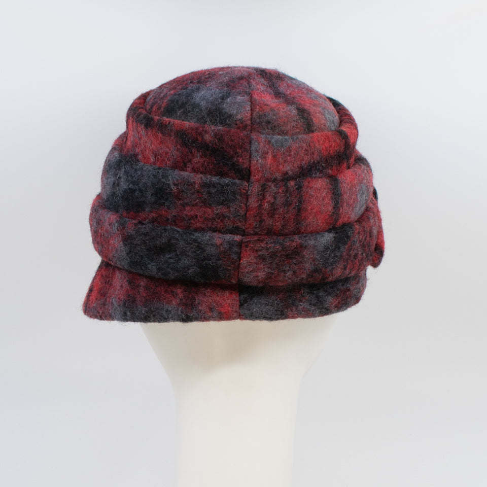 back view of a the lillie & cohoe iconic prints lexi hat. This has has red and grey plaid and a tiered/folded crown. The right side of the hat has a decorative black buckle.