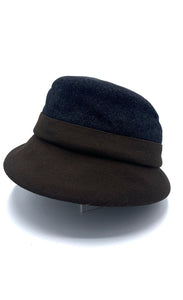 left side view of the lillie & cohoe midnight/brown wool classic alexa hat. This hat is midnight blue on the top and dark brown on the bottom. The hat has a flat brim.