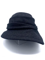 Load image into Gallery viewer, Front view of the lillie &amp; cohoe midnight phoebe wool classic hat. This hat has a tiered/layered crown and an asymmetrical brim that points to the left.
