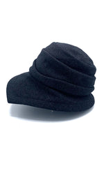 Load image into Gallery viewer, left side view of the lillie &amp; cohoe midnight phoebe wool classic hat. This hat has a tiered/layered crown and an asymmetrical brim that points to the left.
