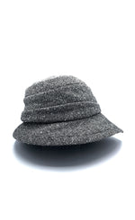 Load image into Gallery viewer, Right side view of the lillie &amp; cohoe herringbone vintage phoebe hat. This hat has an asymmetrical pointed brim, a layered crown, and a grey herringbone pattern.
