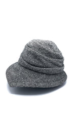 Load image into Gallery viewer, Left side view of the lillie &amp; cohoe herringbone vintage phoebe hat. This hat has an asymmetrical pointed brim, a layered crown, and a grey herringbone pattern.
