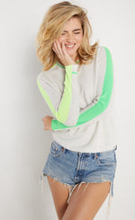 Load image into Gallery viewer, front view of woman wearing lisa todd color pop sweater in the color mineral with lime trim.
