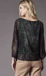 Load image into Gallery viewer, Back top half view of a woman wearing the Lola &amp; Sophie Alligator Chiffon Top. This top is green with an alligator print. The 3/4 length sleeves are slightly sheer.
