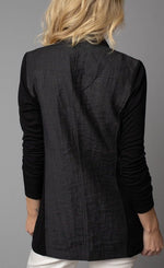 Load image into Gallery viewer, Back, top half view of a woman wearing the Lola &amp; Sophie Crinkle Linen Zip-Front Long Black Jacket. This jacket has a linen body with fitted long soft fabric sleeves.
