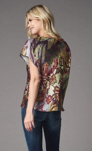 Front back view of a woman wearing the lola & sophie fairytale top. This top has short sleeves and a bias cut. The print on the top has warm autumn colors mixed in with a wine colored floral print.