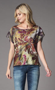 Front top half view of a woman wearing the lola & sophie fairytale top. This top has short sleeves and a bias cut. The print on the top has warm autumn colors mixed in with a wine colored floral print.