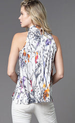 Load image into Gallery viewer, Back top half view of a woman wearing the lola &amp; sophie floral sketch halter top. This sleeveless top is white with black sketch flowers and small watercolor-like splashes of color. The back of the top has s zipper at the neck.
