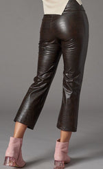 Load image into Gallery viewer, Back bottom half view of a woman wearing the lola &amp; sophie vegan leather kick flare pant. This pant is grey colored with a subtle crocodile print, a cropped leg, and a flared out bottom.
