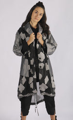 Load image into Gallery viewer, Front full body view of a woman wearing the luukaa abstract jacquard organza jacket. This mid-length jacket has a black see-through organza body with grey sleeves, a grey collar, grey pockets, and a grey abstract print.
