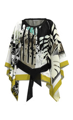 Load image into Gallery viewer, front view the luukaa belted poncho. This poncho is white with mustard trim and black and teal leaf print all over it.
