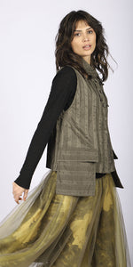 Load image into Gallery viewer, Right side top half view of a woman wearing a brown vest over a black long sleeve top. On the bottom she is wearing the luukaa floral tulle skirt in khaki. This skirt has khaki tulle and a floral lining that shows through underneath. The skirt sits below the knees.
