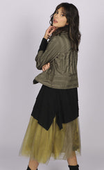Load image into Gallery viewer, Back full body view of a woman wearing a brown jacket over a black long sleeve top. On the bottom she is wearing the luukaa floral tulle skirt in khaki. This skirt has khaki tulle and a floral lining that shows through underneath. The skirt sits below the knees.
