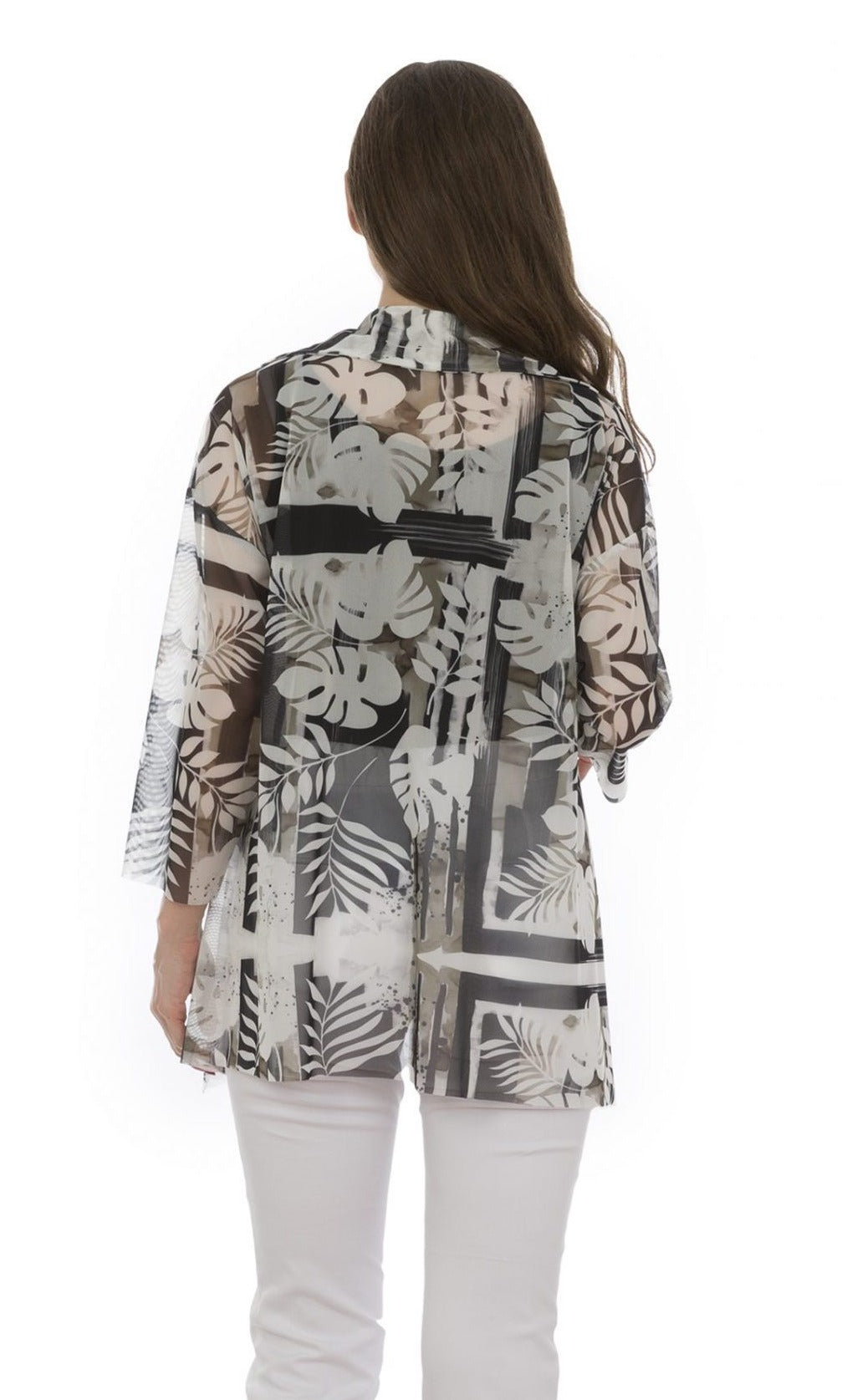 Back top half view of a woman wearing white capris and the luukaa leaf print top. This top is sheer with white and grey leaf print. The sleeves are 3/4 length and the hem is long in the back.
