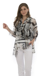 Load image into Gallery viewer, Front top half view of a woman wearing white capris and the luukaa leaf print top. This top is sheer with white and grey leaf print. The sleeves are 3/4 length, the neck is a v-neck, and the hem is short in the front and long on the sides.
