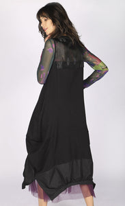 Back full body view of a woman wearing the luukaa long sleeveless dress. This dress is black with a tulle neckline and a structured fabric hem. The dress balloons out near the bottom.