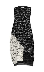 Load image into Gallery viewer, Front view of the luukaa scribbles dress. The sleeveless dress is black with white handwriting. The right side near the bottom has white with black handwriting. The dress comes down below the knees with some mesh trim. 

