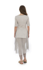 Load image into Gallery viewer, Back full body view of a woman wearing the luukaa stone leggings in the color beige. They have mesh trim on the bottom. On the top the model is wearing the luukaa tunic in beige.
