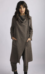 Load image into Gallery viewer, Front full body view of a woman wearing brown cropped pants and the luukaa wrap coat/jacket. This jacket/coat is mink/dark brown with a shawl collar, two front pockets, and long sleeves.
