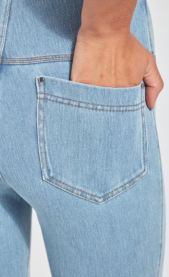 Back, close up view of the back pocket on the Lysse Evelyn Split crop denim legging in a light wash. The model has her hand in the pocket.