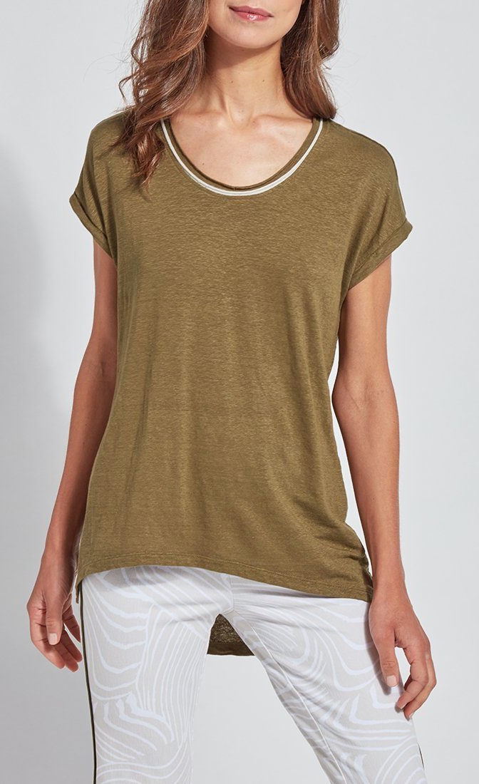 Front top half view of a woman wearing the lysse classic tee. this tee is jungle khaki colored. It has short drop shoulder sleeves, a high low hem, and white edging around the round neck. 