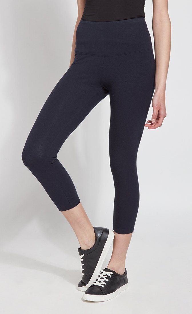 Front bottom half view of a woman wearing Lysse's Flattering Cotton Crop Legging. These leggings are navy and have a high-rise, large waistband.