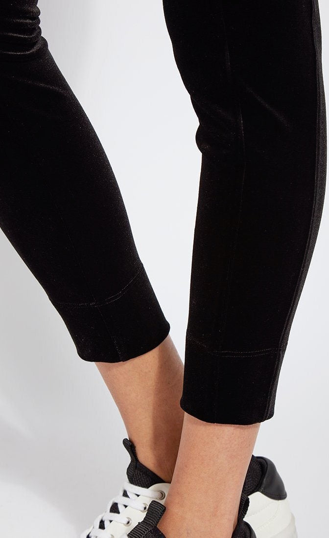 Close up bottom view of a woman wearing the lysse nook velvet jogger. This black jogger is body hugging like a legging with side pockets and a high-waisted tie waistband.