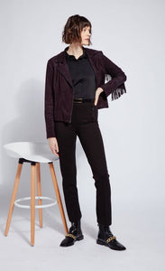 Front full body view of a woman wearing black pants and the black lysse spice fringe jacket. This jacket is suede looking. It has fringe all along the arms and back and a front zipper.