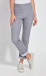Front bottom half view of a woman standing with one leg crossed in front of the other wearing the Lysse Boyfriend Denim pants. These pants are grey, cuffed, and have a straight leg.