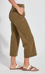 Load image into Gallery viewer, Right side bottom half view of a woman wearing the lysse jade wide leg crop denim pant. This pant is khaki colored. It has side patch pockets with top stitching, a flat front, and a hem that sits above the ankles.
