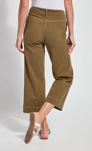 Back bottom half view of a woman wearing the lysse jade wide leg crop denim pant. This pant is khaki colored. It has contrasting white stitching and a hem that sits above the ankles.