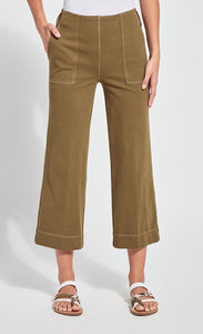 Front bottom half view of a woman wearing the lysse jade wide leg crop denim pant. This pant is khaki colored. It has side patch pockets with top stitching, a flat front, and a hem that sits above the ankles.