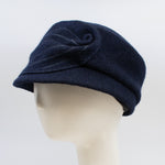 Load image into Gallery viewer, Left side view of the mao now hat in navy. This hat has a large stitched leaf on the left side.
