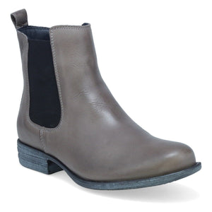 Outer front side view of the miz mooz lewis bootie in the color graphite/grey. This flat bootie has black elastic gores on the side and a pull tab on the back.