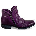 Load image into Gallery viewer, Outer view of the miz mooz luna bootie in a deep dark purple color. This flat bootie has a zipper on the side and decorative zipper trim around the front and back opening for the foot.
