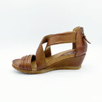 Load image into Gallery viewer, Inner side view of the miz mooz monarch sandal in the color brandy. This sandal has two leather straps that criss cross over the instep and another strap over the toes. The back of the sandal has a zipper and the sandal has a small wedge heel.
