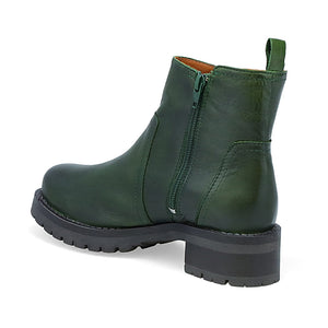 inner side view of the miz mooz poolie bootie in the color kiwi (green). This bootie has an inner side zipper and a lug sole.