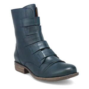 Outer front view of the miz mooz leighton boot. This boot is ocean (dark blue) colored. It is slightly taller than ankle height and has decorative straps all along the front.