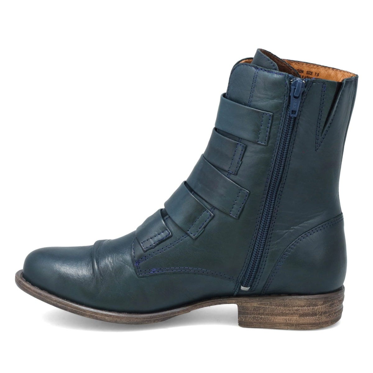 Inner view of the miz mooz leighton boot. This boot is ocean (dark blue) colored. It is slightly taller than ankle height and has decorative straps all along the front.