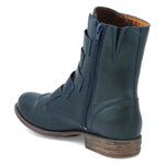 Load image into Gallery viewer, Inner back view of the miz mooz leighton boot. This boot is ocean (dark blue) colored. It is slightly taller than ankle height and has decorative straps all along the front.
