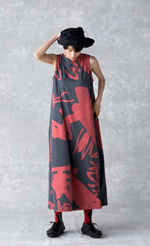 Load image into Gallery viewer, Front full body view of a woman wearing the moyuru art print dress. This sleeveless dress is charcoal with a red abstract print and a-line silhouette.
