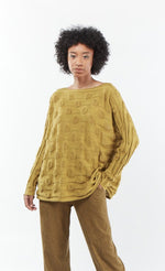 Load image into Gallery viewer, Front top half view of a woman wearing the mxmatthildur bubble sweater. This sweater features a bubble/jacquard textured fabric print, long sleeves, a boxy shape, and a boat neck.

