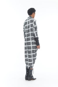Back full body view of a woman wearing the mxmatthildur carly dress. This long sleeve dress has a white and black plaid print.