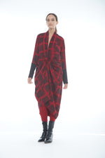 Load image into Gallery viewer, Front full body view of a woman wearing the mxmatthildur carly dress. This long sleeve dress has a red and black plaid print. It is also knotted in the front and gathers in the middle.
